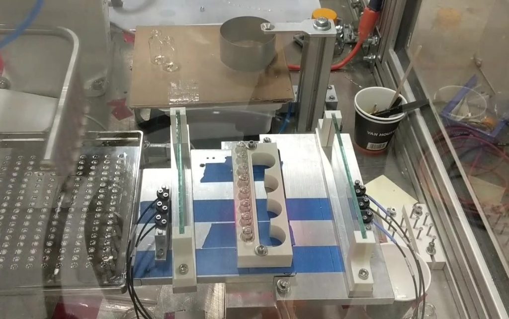 An experimental set-up of glass vials and a tray of lyobeads used to demonstrate a technology concept
