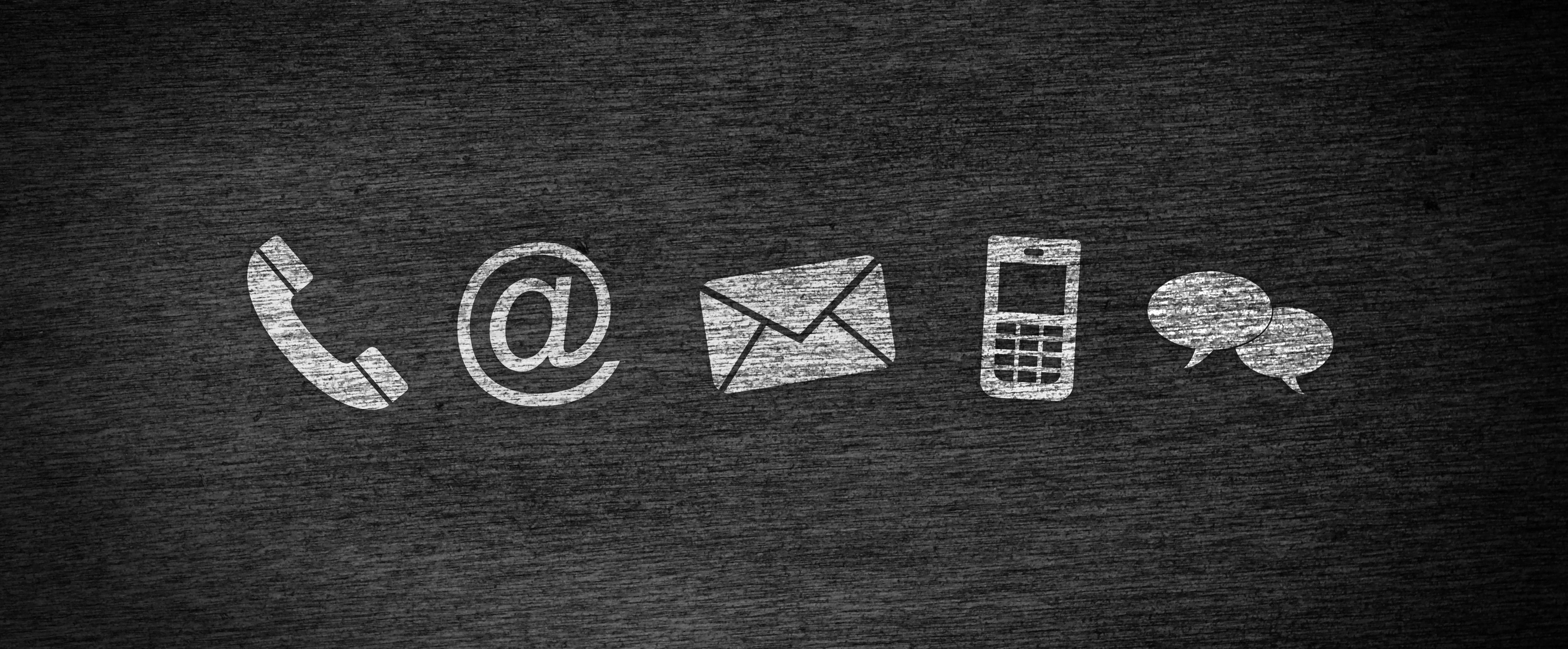 Grey icons for phone, email, mail, mobile phone, and chat.phone on black background