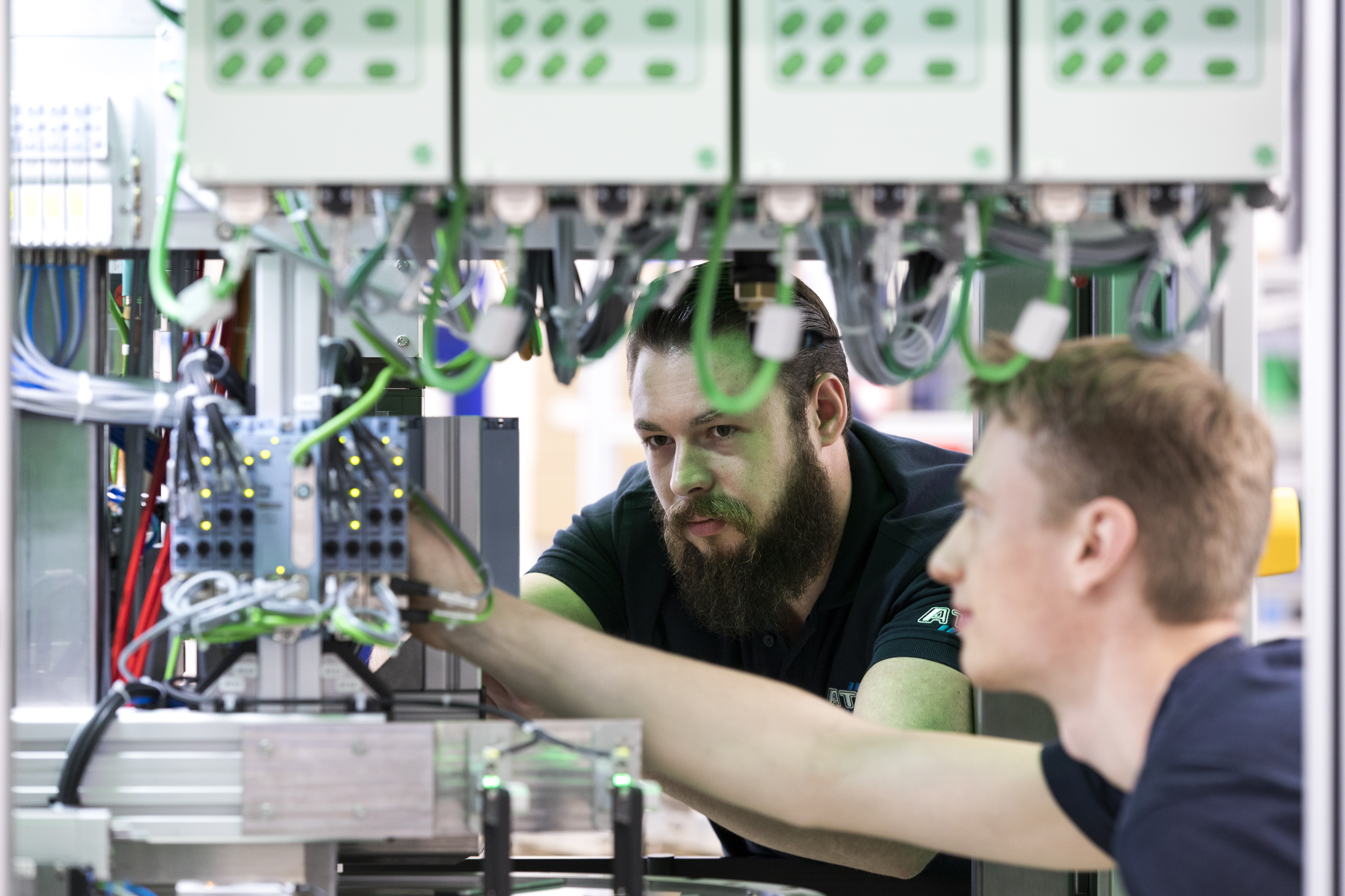 Two men work together in a facility